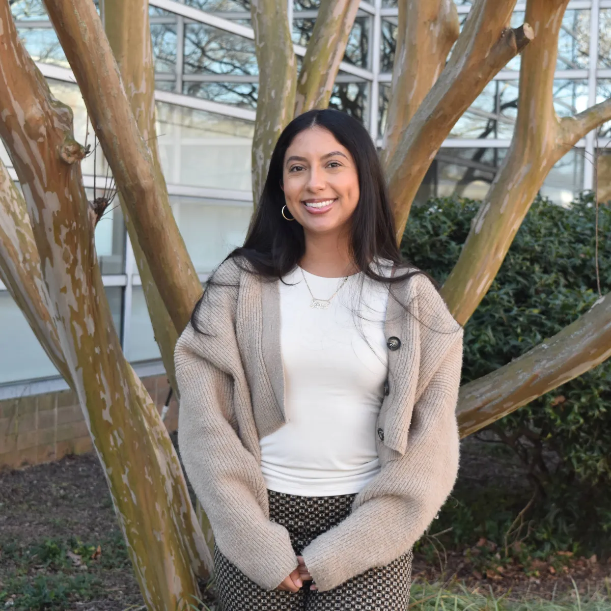 person standing in front of tree with beige cardigan